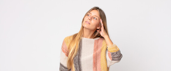 blonde pretty woman looking serious and curious, listening, trying to hear a secret conversation or...