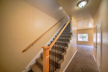 Interior of an empty house with stairs and carpeted flooring
