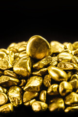 many gold nuggets on isolated black background, concept of wealth and rare ores