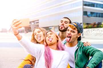 Happy young multiracial people meeting outdoors - Group of cheerful teenagers having fun and taking an selfie with a smartphone, concepts about teenage, lifestyle and generation z
