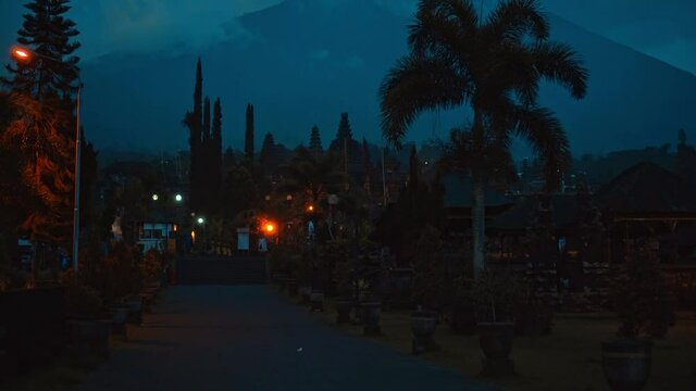 street at night in the dark with clouds and blue skies in the background covering the volcano