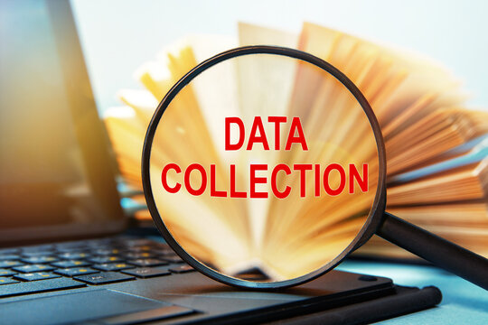 Laptop computer, books and magnifying glass with text DATA COLLECTION