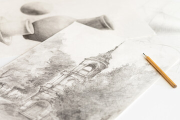 Drawings made in pencil are on the table.