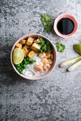 Fototapeta na wymiar asian rice noodle soup with fried tofu and shrimps