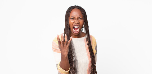 afro black adult woman looking angry, annoyed and frustrated screaming wtf or what’s wrong with...