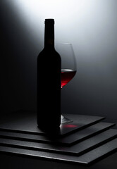 Bottle and glass of red wine.