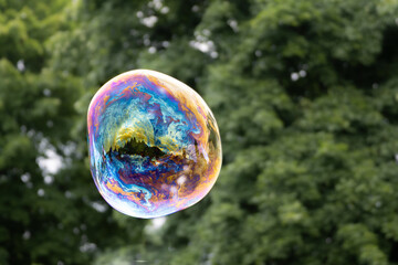 Releasing huge colorful soap bubbles in the open air