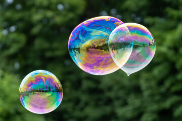 Releasing huge colorful soap bubbles in the open air