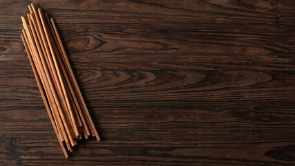 Oriental chopsticks on wooden background with copy space