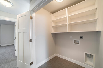 Interior of an empty laundry room with folding door