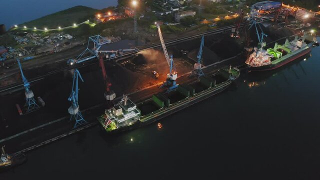 A drone view of cargo cranes working early in the morning at dawn