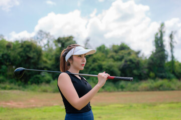 Portrait of golfer asian woman holding golf wood at the country club,Happy woman concept