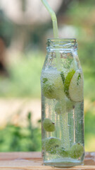 fresh cooling lemonade with ice. drink with lime and gooseberry. bubbles in liquid