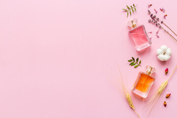 Perfume bottles flat lay with flowers and leaves, top view