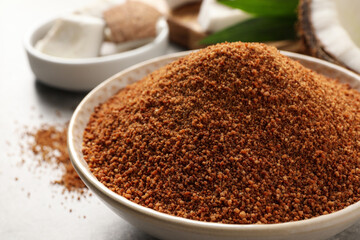 Natural coconut sugar in ceramic bowl, closeup