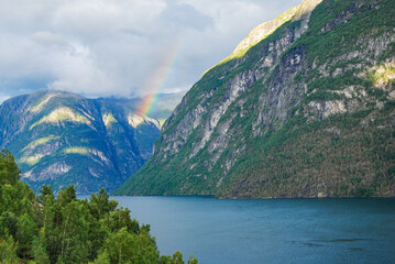 Naklejka na ściany i meble Rainbow over fjords in Norway, near the village of Hellesylt