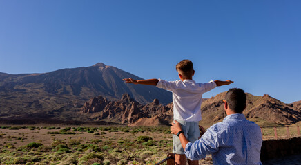 tourism family in tenerife watching the teide
