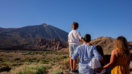 tourism family in tenerife watching the teide
