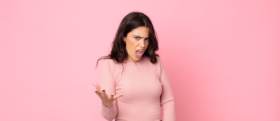 young pretty woman looking angry, annoyed and frustrated screaming wtf or what’s wrong with you