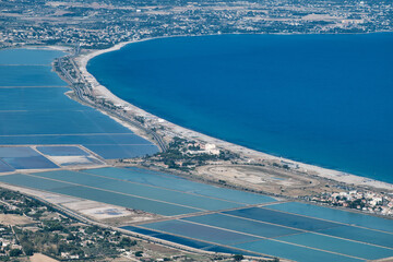 aerial view of (Poetto beach ) seashore of the city of (Cagliari) with salinas field - Sardinia - Italy.