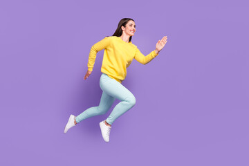 Fototapeta na wymiar Full length body size view of attractive cheerful motivated girl jumping running isolated over violet purple color background