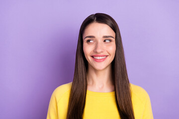 Fototapeta premium Portrait of attractive cheerful curious long-haired girl looking aside copy space isolated over violet purple color background