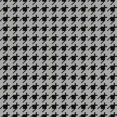 Knitted black and white goose foot pattern. Seamless  fabric design. Vector illustration.