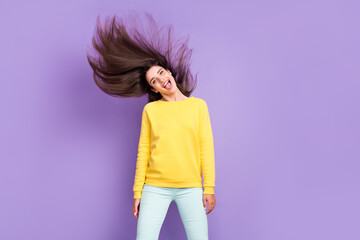 Portrait of attractive carefree cheerful girl dancing having fun throwing hair isolated over violet purple color background