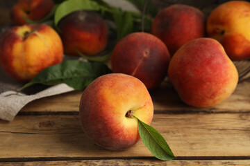 Fototapeta na wymiar Fresh ripe juicy peaches on wooden table, closeup