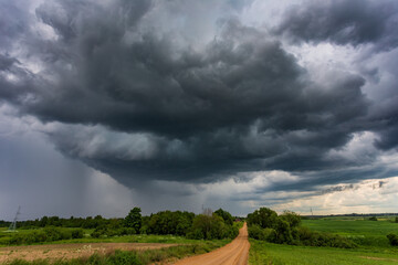 Extreme thunderstorm clouds moving over fields, climate change concept