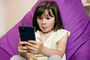 Portrait teenager girl holding smart phone. Child Browsing Internet on Phone, Teenager Girl Reading Messages, Searching Online on Devices. Kid Playing Smartphone. Mobile technology concept