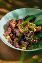 Grilled BBQ pork ribs with sesame seeds and peanuts. Chinese recipe and cuisine.