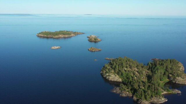 Aerial view on the lake and Islands with rocky coastline and forest in Karelia. Drone view on the beautiful Ladoga lake. Skerriy in the northwestern part of the Lake Ladoga