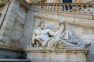 Fototapeta na wymiar Statue of Tiberinus in front of the Palazzo Senatorio (Senatorial Palace) at the Piazza del Campidoglio in Rome, Italy