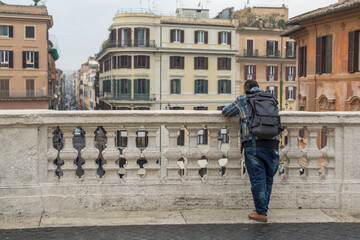 A tourist watching the Piazza di spagna from Spanish Steps in Rome, Italy