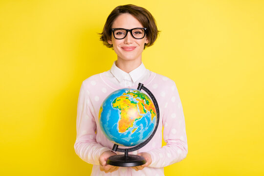Photo portrait female geek keeping globe at school smiling isolated bright yellow color background