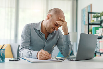 Exhausted businessman working from home