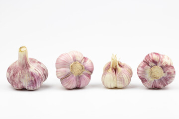Four heads of garlic close-up isolated on white background.