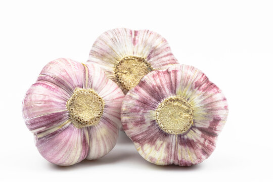 Three heads of garlic isolated on a white background.