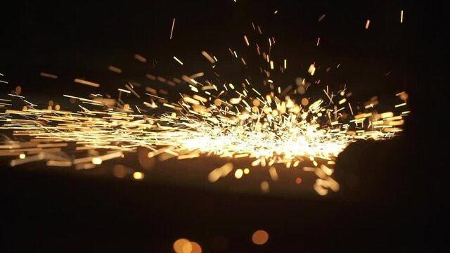 Close up construction worker cutting steel beam. Hot metal sparks. High quality FullHD footage