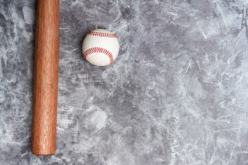 Baseball ball and bat on grey background. Team sport concept