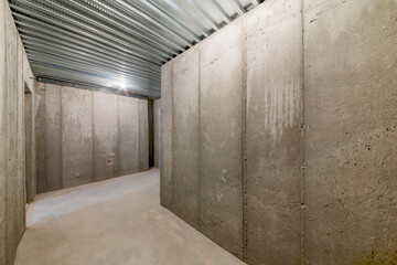 Unfinished empty cold storage room in a basement of a house