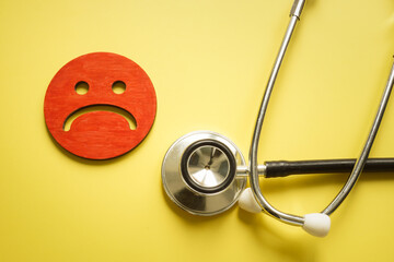Bad patient satisfaction concept. Stethoscope and sad unhappy face.