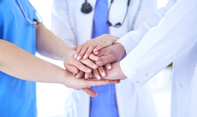 Group of doctors putting their hands together. Close-up