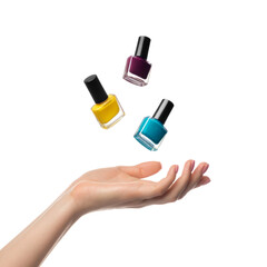 Obraz premium Nail polish bottles levitate, flying over a woman's hand