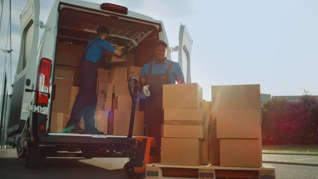 Outside of Logistics Distributions Warehouse: Diverse Team of Workers use Hand Pallet Truck Start Loading Delivery Truck with Cardboard Boxes, Online Orders, Purchases, E-Commerce Goods. Wide Pan