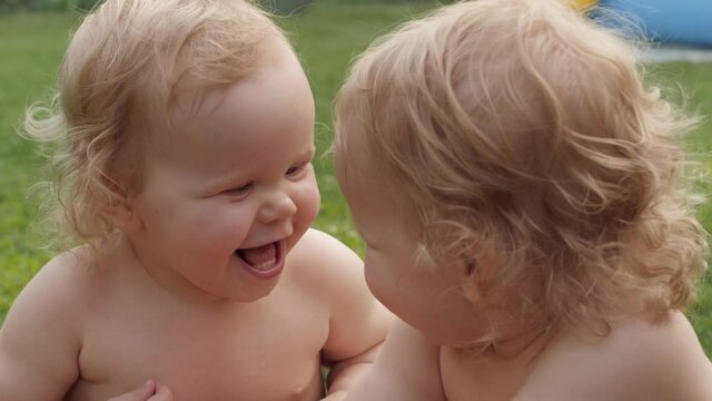 Closeup funny cute little baby twins laughing spending time together outdoor village countryside