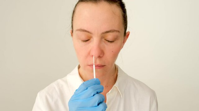 Self-test to obtain PCR. Coronavirus, flu nasal swab test collection female for viral pandemic COVID-19 diagnosis. Nurse collecting nasopharyngeal specimen