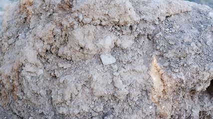 Close up of dry dirt and rocks and sunlight hitting on it