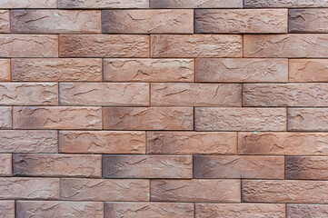Wall of decorative tiles in the form of old bricks for background